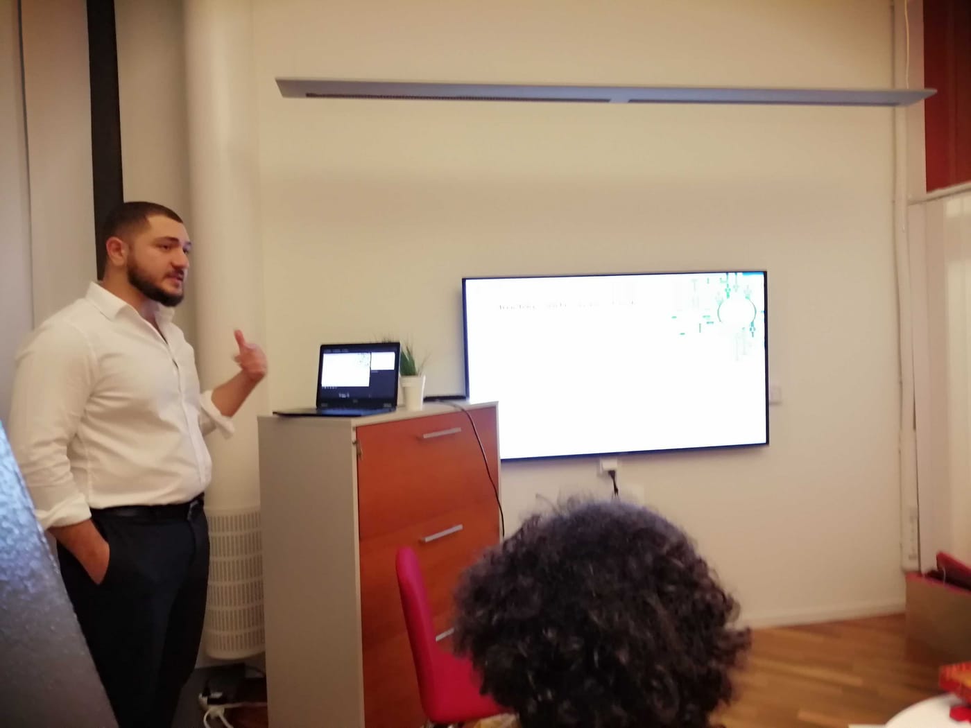 SwedQ engineer presenting to colleagues in front of a screen