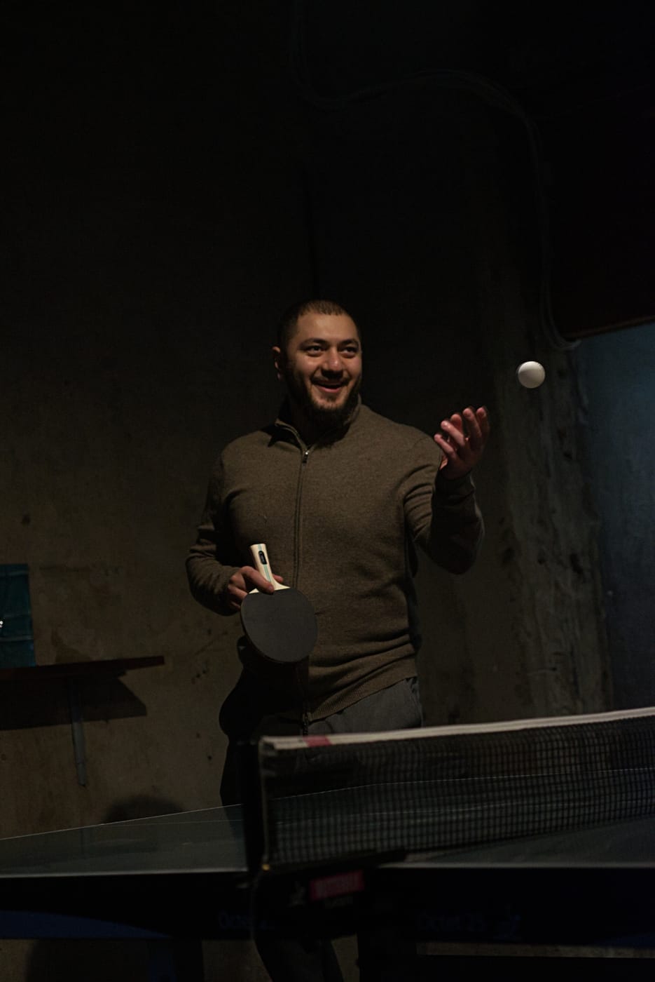 SwedQ colleague serving during a table tennis match